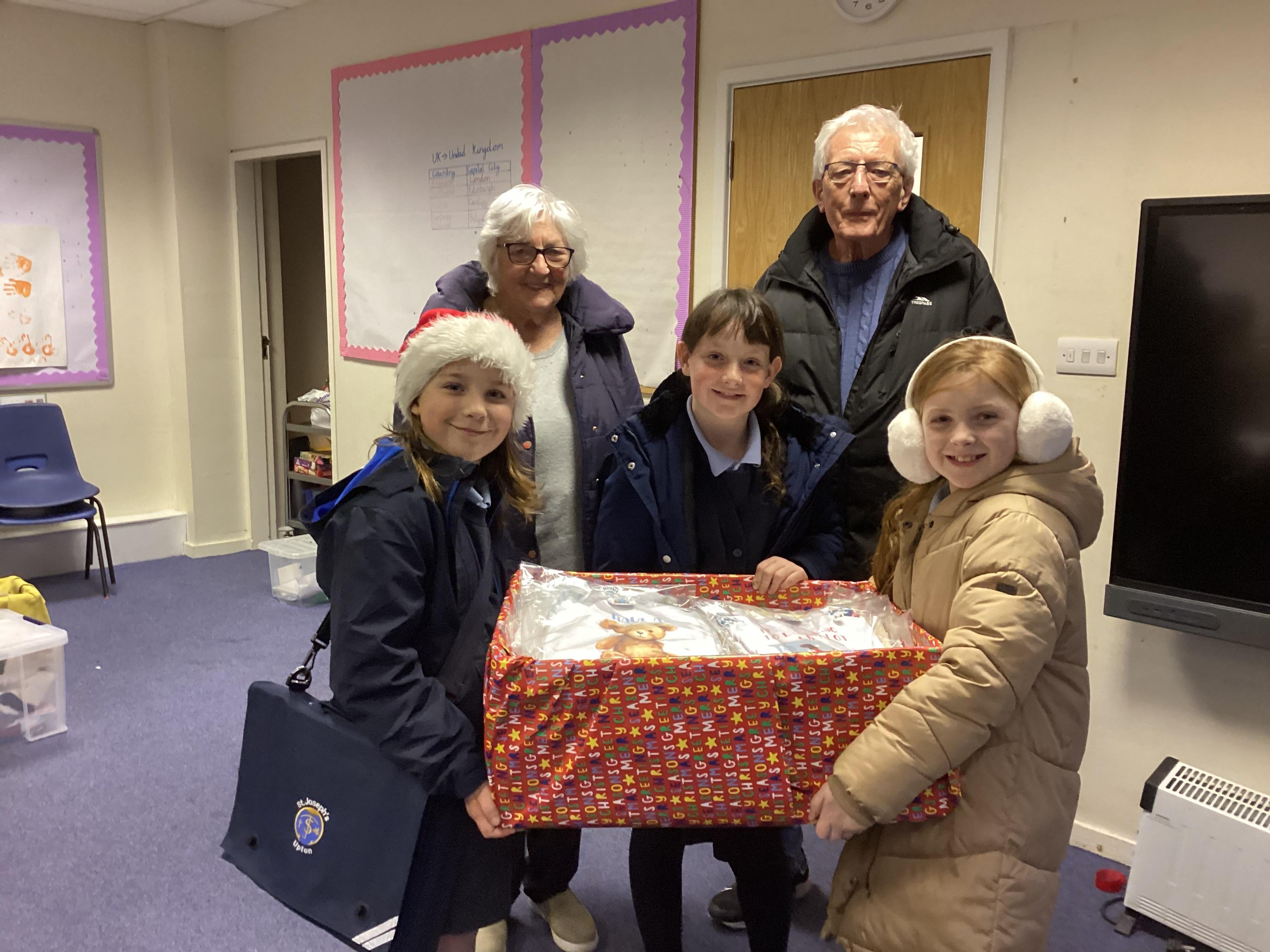 This is an image of children and SVP members working together