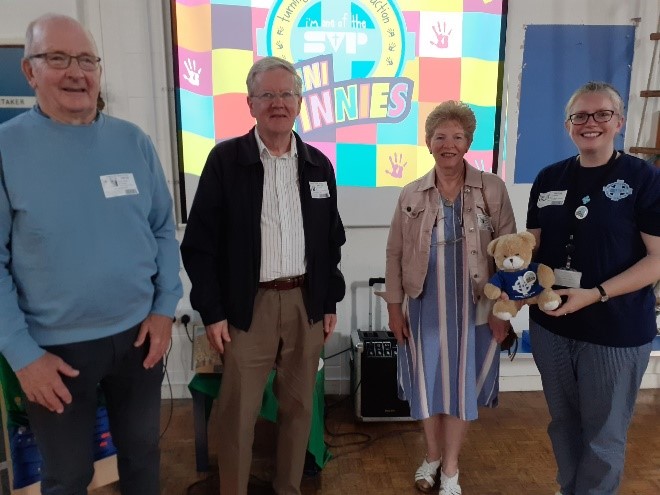This is a photo of the Mini Vinnies Manager and three SVP members