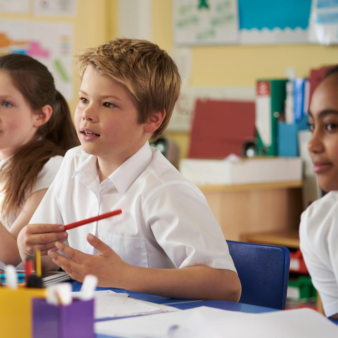 This is an image of three children listening to a talk in class.