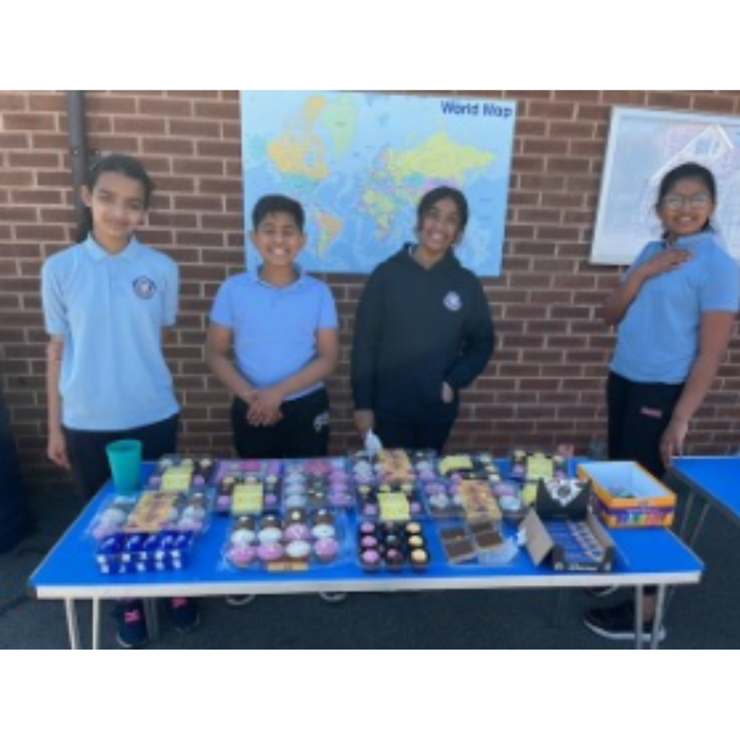 This is a picture of the Mini Vinnies doing a cake sale.