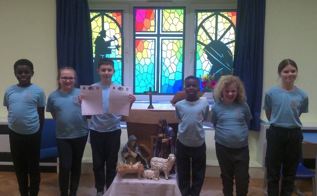 This is a photo of the Mini Vinnies at St Luke's Academy in Essex holding up the letter they wrote to their MP.