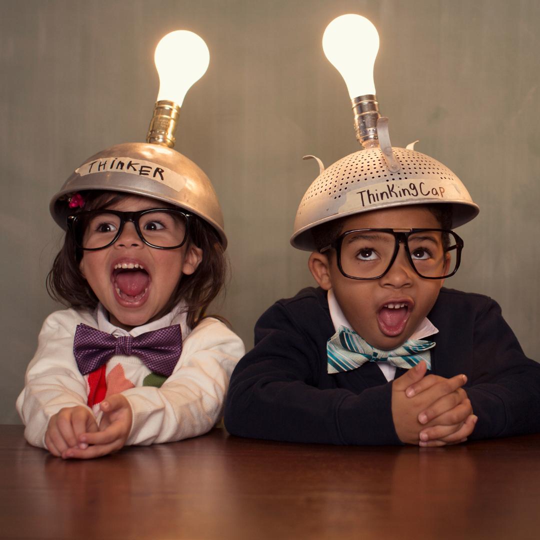 This is a photo of two children with thinking caps on.