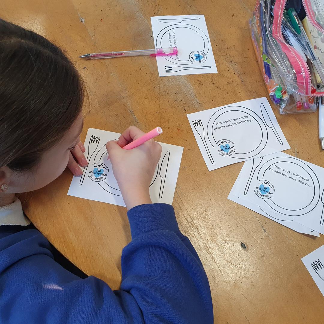 This is an image of a child completing a template for sharing at the table.