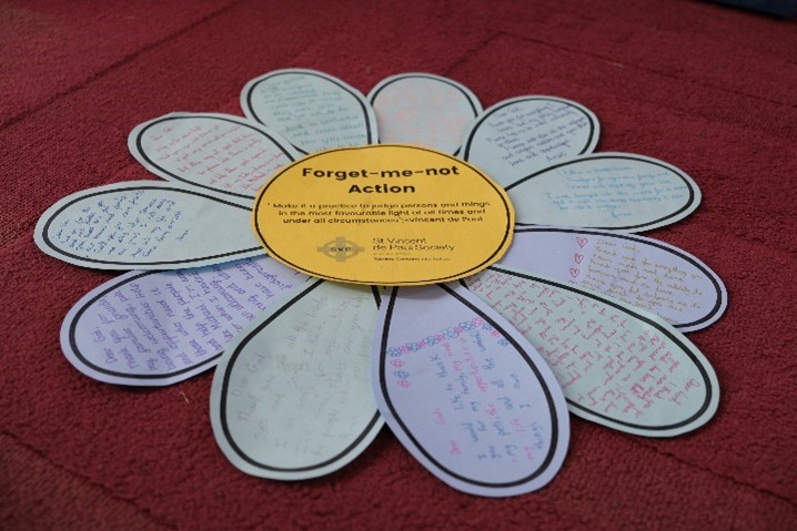 This is a photo of the finished forget-me-not flower with handwritten prayers by the children.