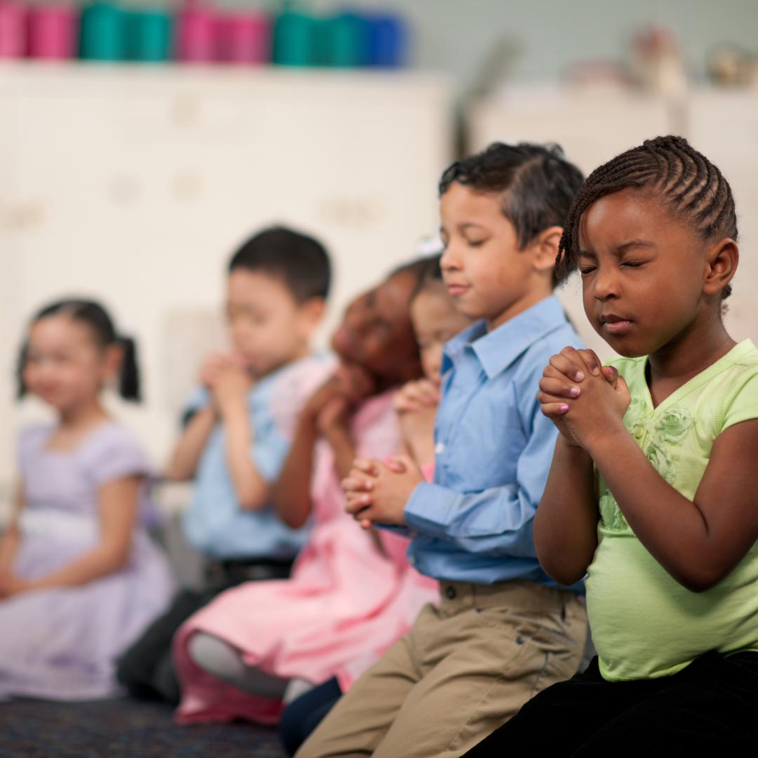 An image of children praying