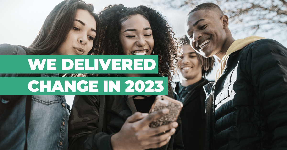 We delivered change in 2023: Group of friends looking at mobile phone and laughing