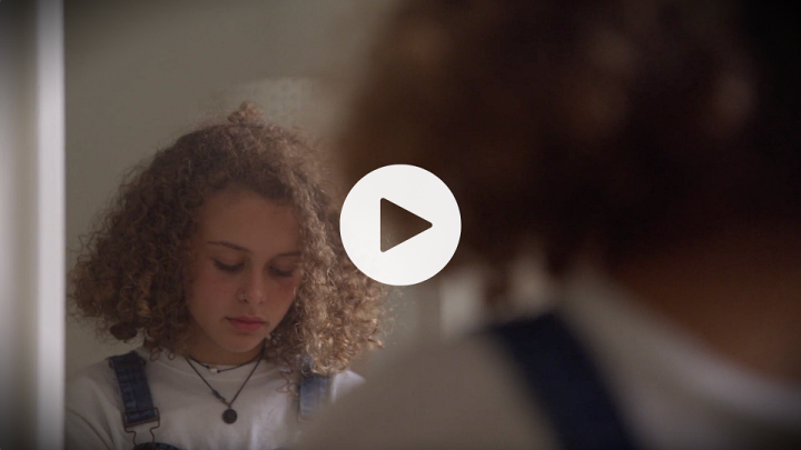 PSA screenshot of a young girl looking sad