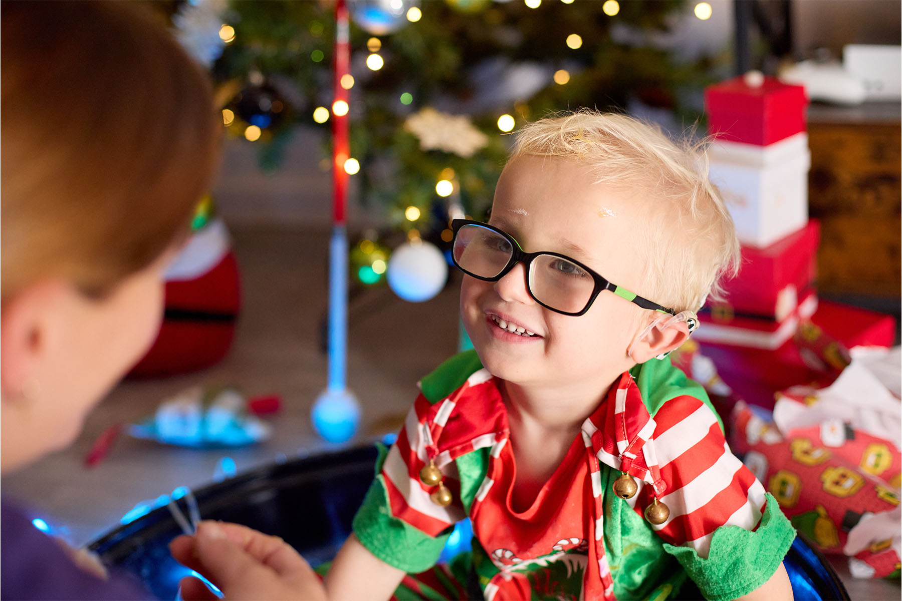 Harvey is a blond-haired boy wearing a Christmas elf outfit