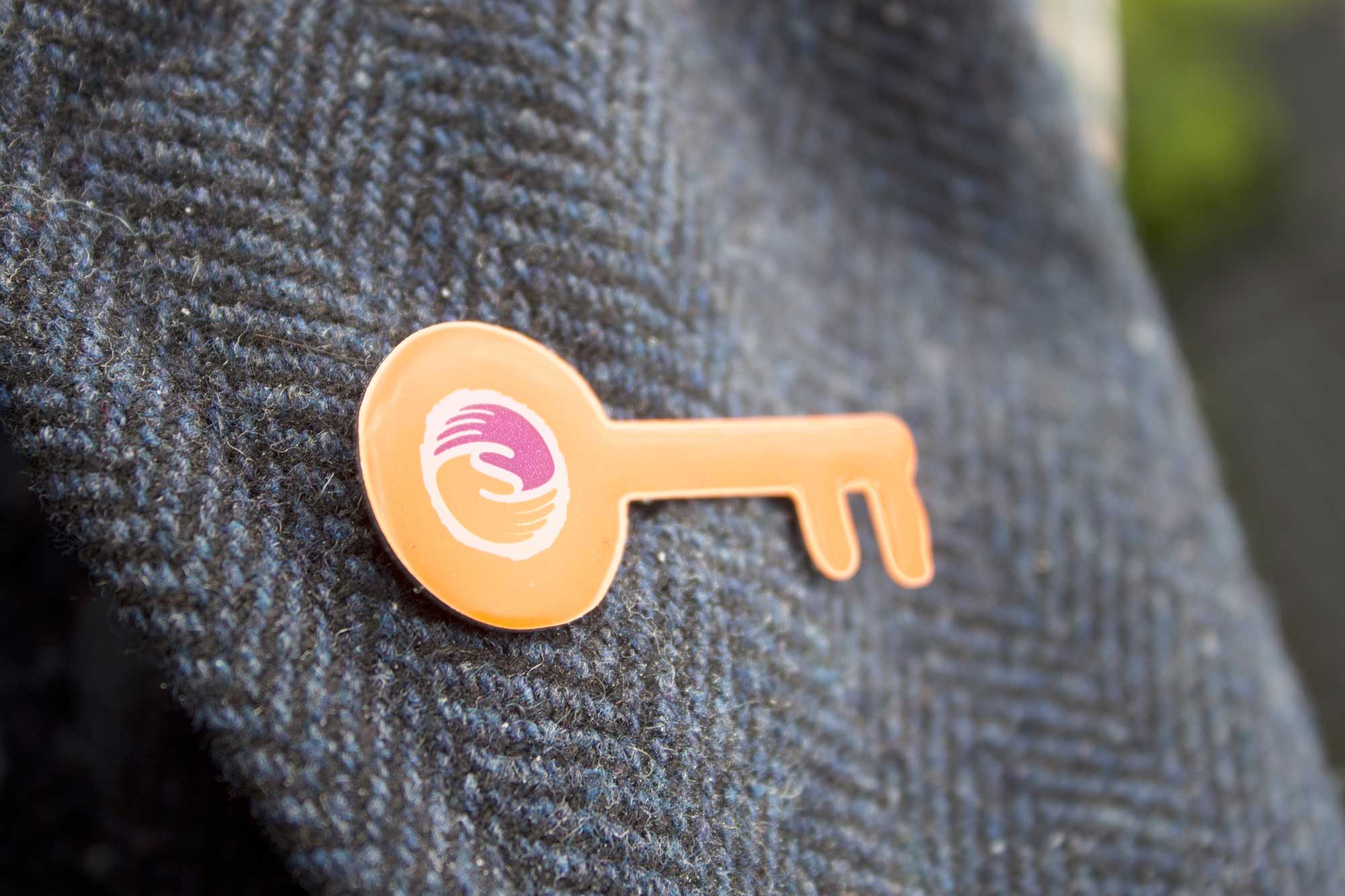 magic key pin badge on a coat