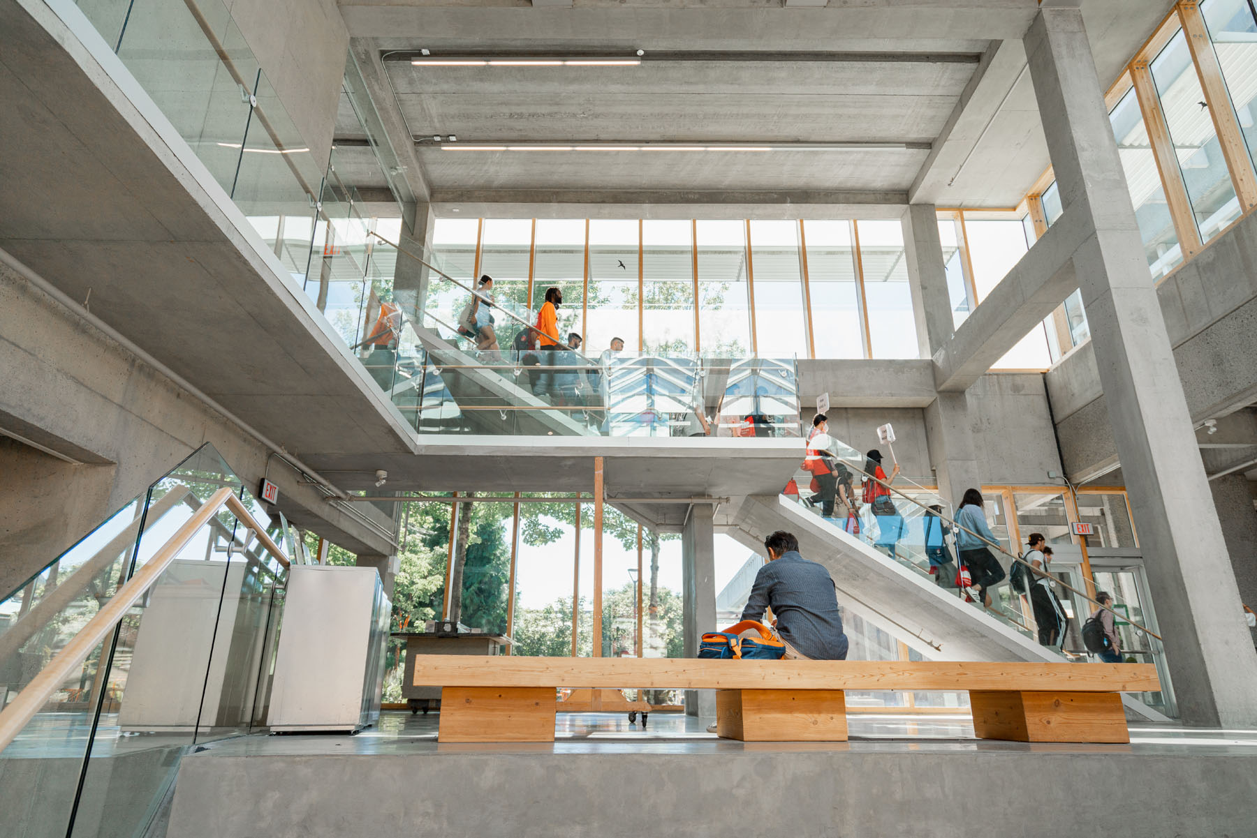 SFU students moving through a bright campus atrium
