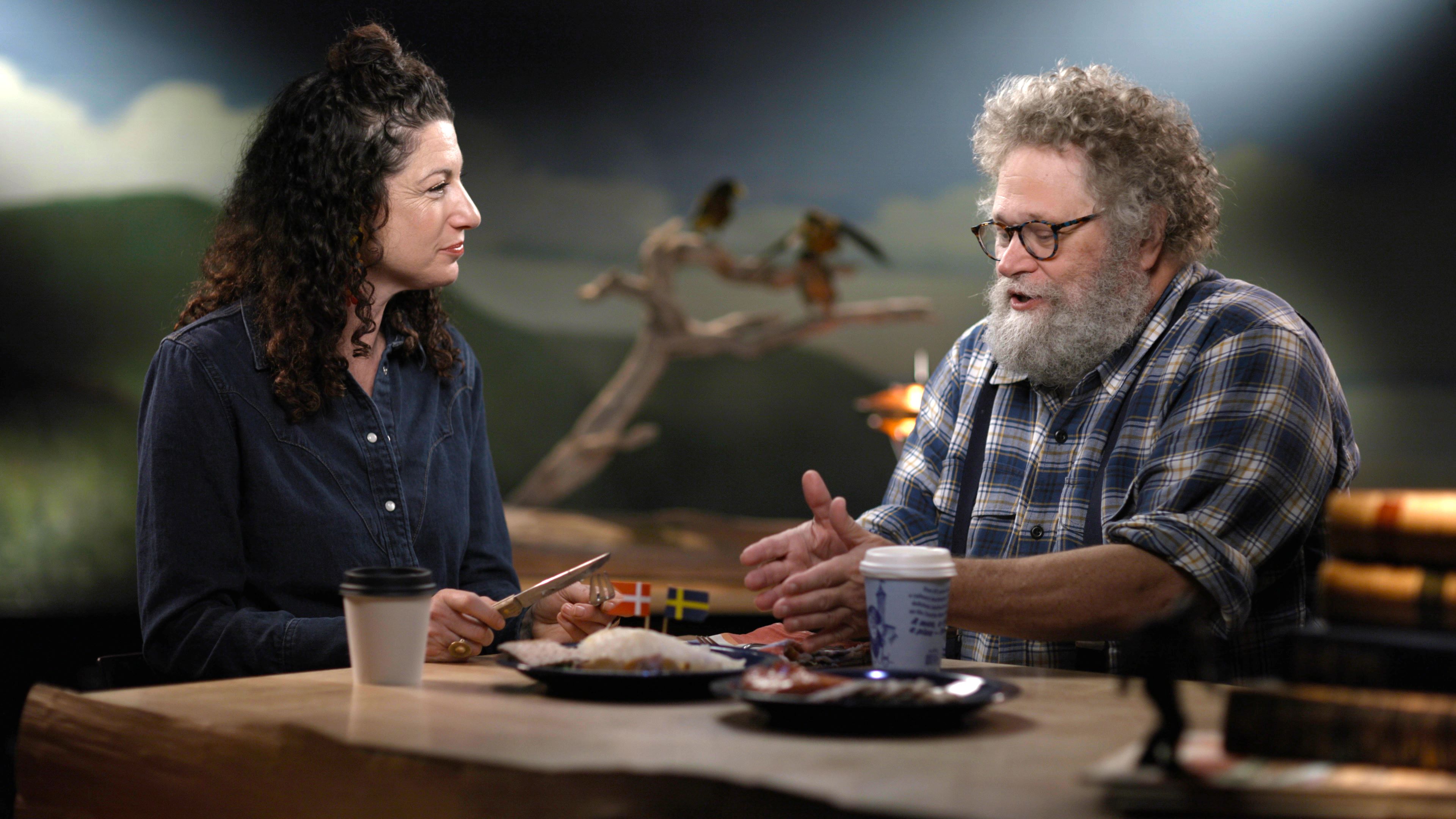 Knute Berger and Rachel Belle sit talking and eating