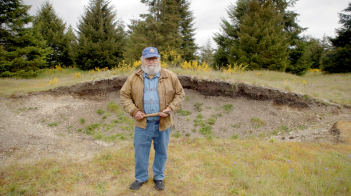 Knute Berger stands on the prarie at Mima Mounds