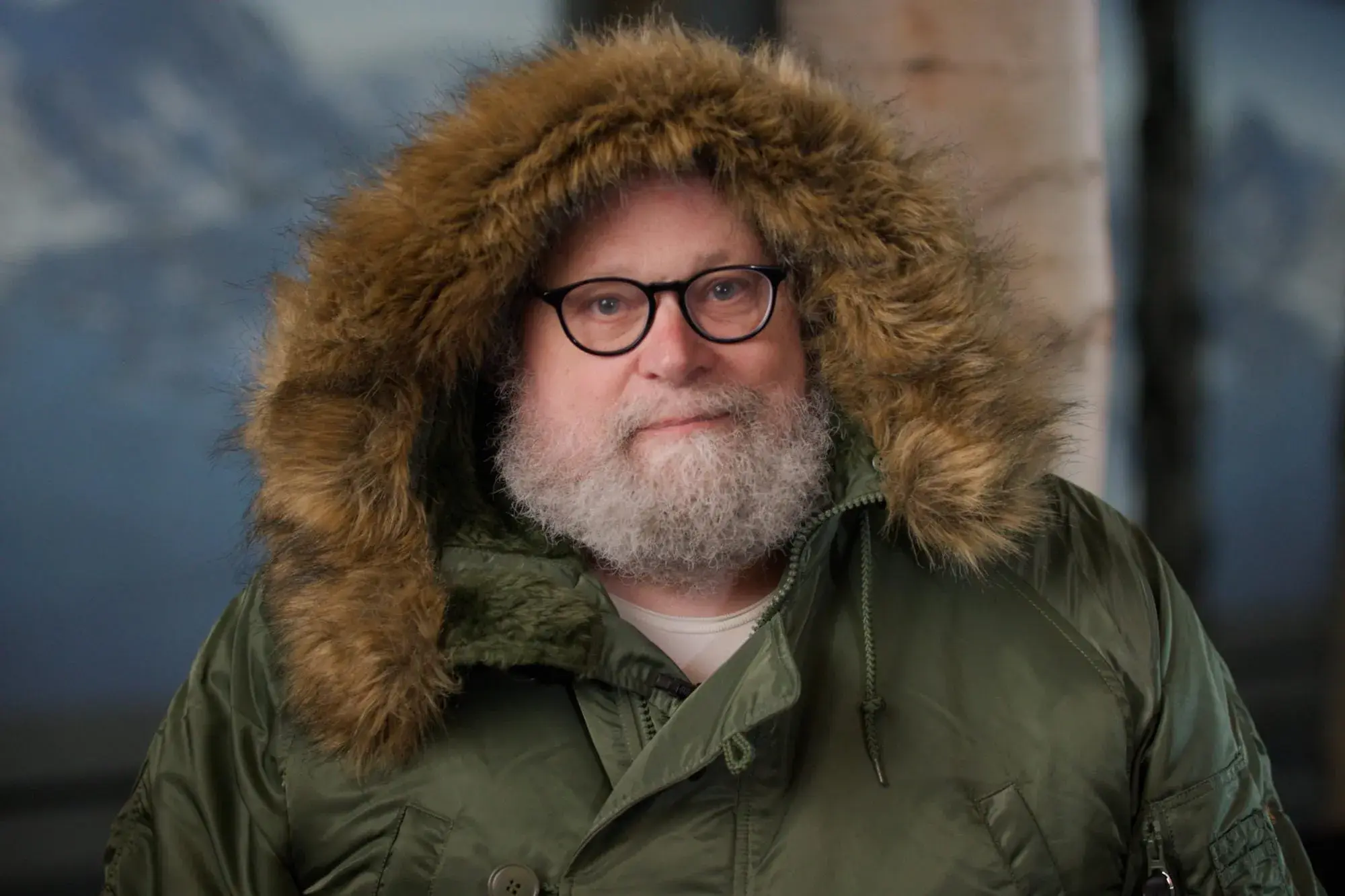 Knute Berger sits wearing a parka with a furry hood