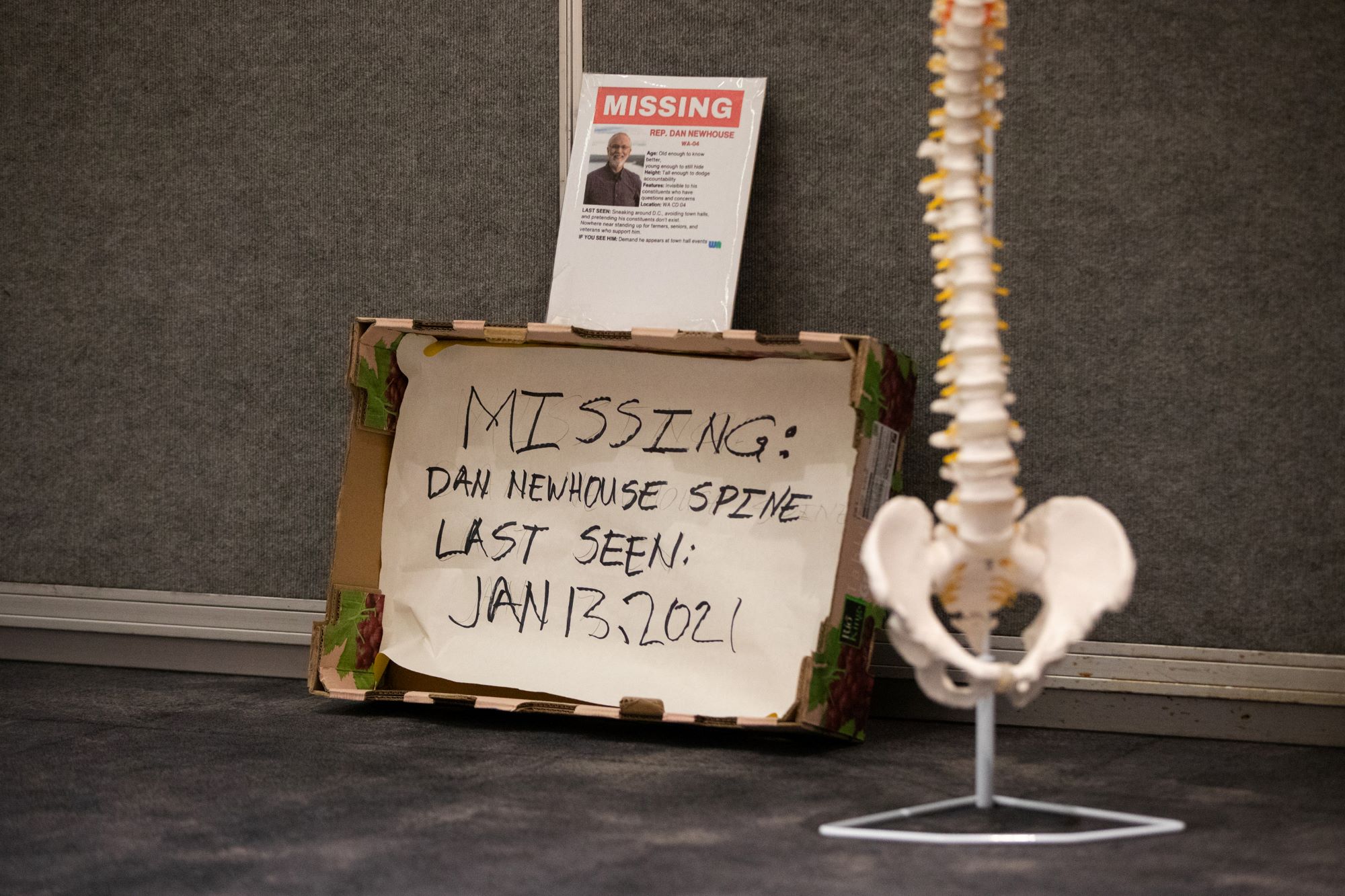 A plastic spine with a missing sign next to it