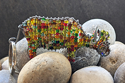 A buffalo-shaped keyring made out of wire and beads