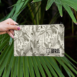 A hand holding a pencil case with jungle cats pattern
