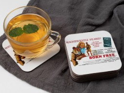 A photo of the Born Free film poster on a coaster, with a mug of tea seen next to it.