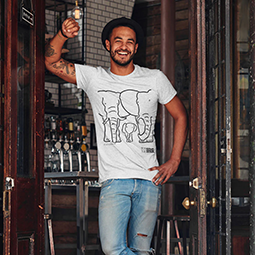 A man leaning against a door wearing a grey t-shirt with elephant design