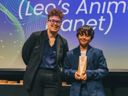 A photo of Born Free Junior Ambassador, Leo, receiving an award on stage.