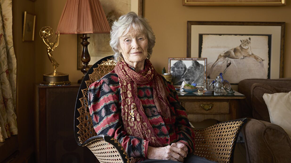 Dame Virginia McKenna sitting in a wicker chair with hands clasped together