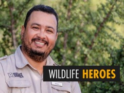 A photo of Glen Vena in a Born Free / Shamwari uniform, smiling at the camera. The words 'WILDLIFE HEROES' are overlaid.