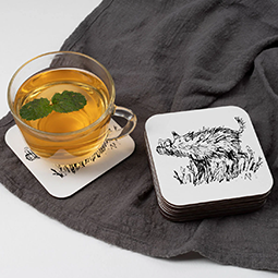 A stack of coasters with warthog illustration and a single coaster with a mug of green tea on it