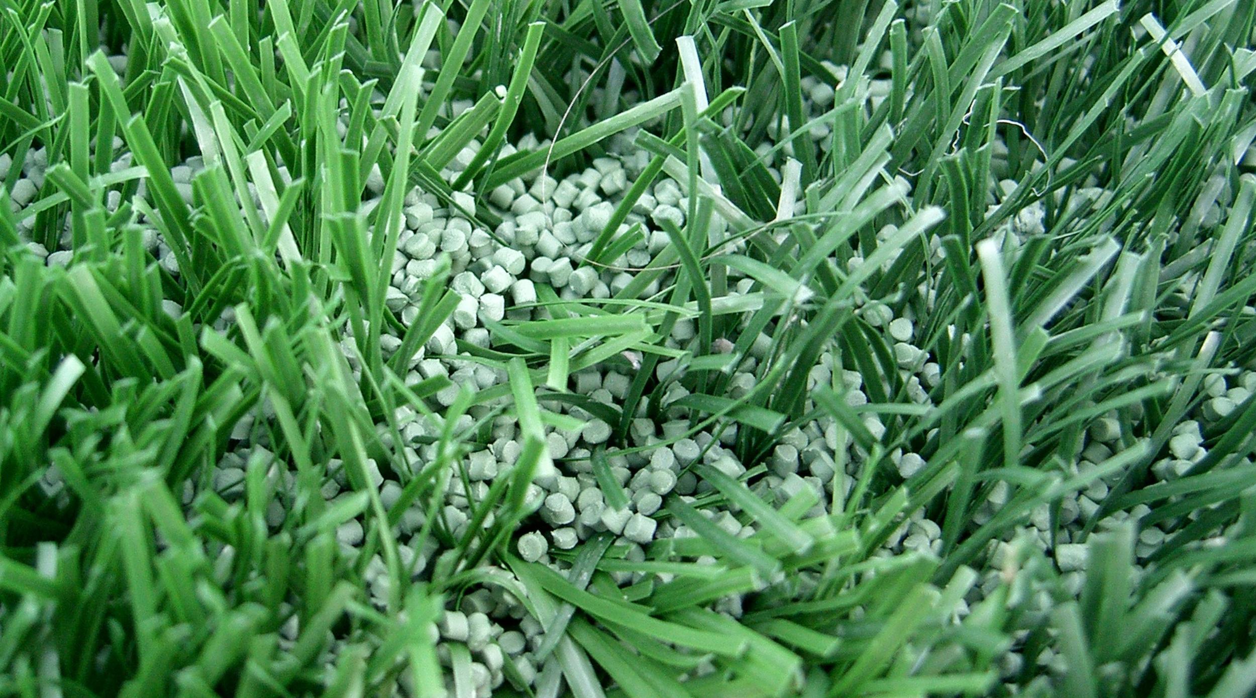 Image of artificial turf showing the plastic filler used inside