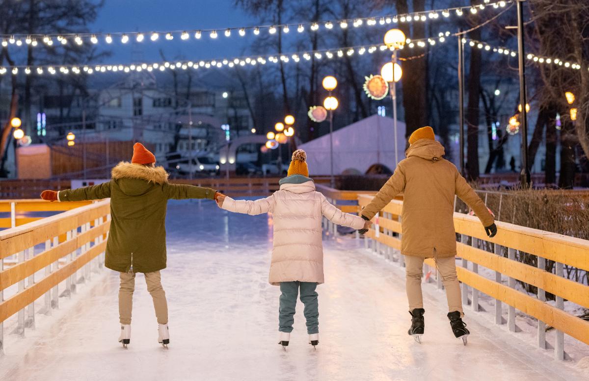 Family ice skating in winter