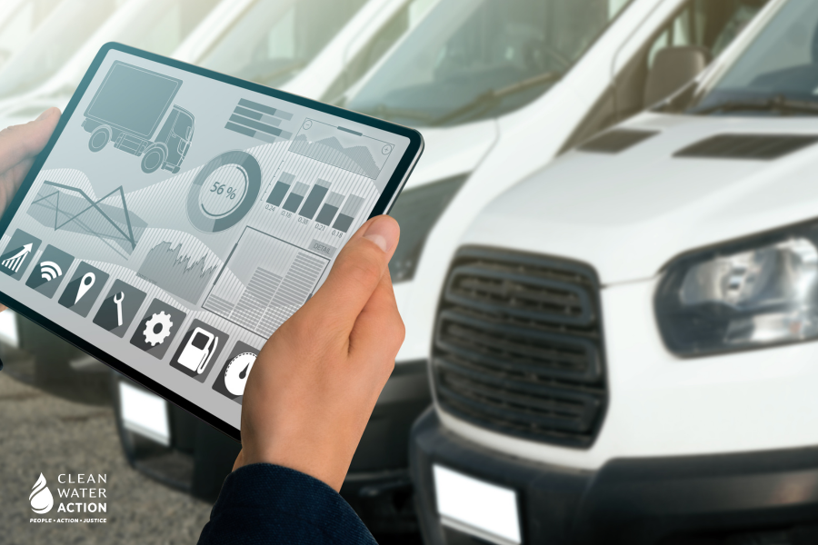 Manager with a digital tablet on the background of trucks. Fleet management.