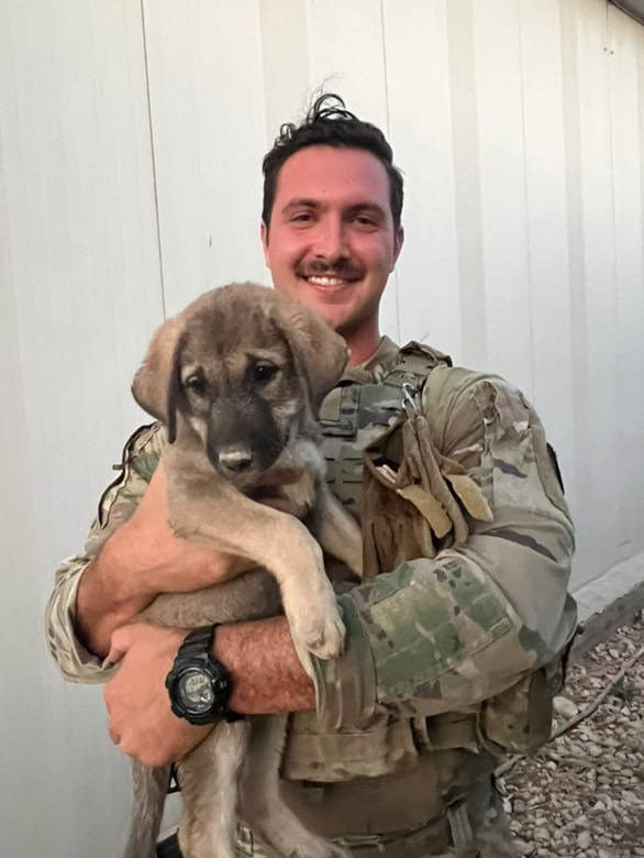 Photo of soldier and dog.