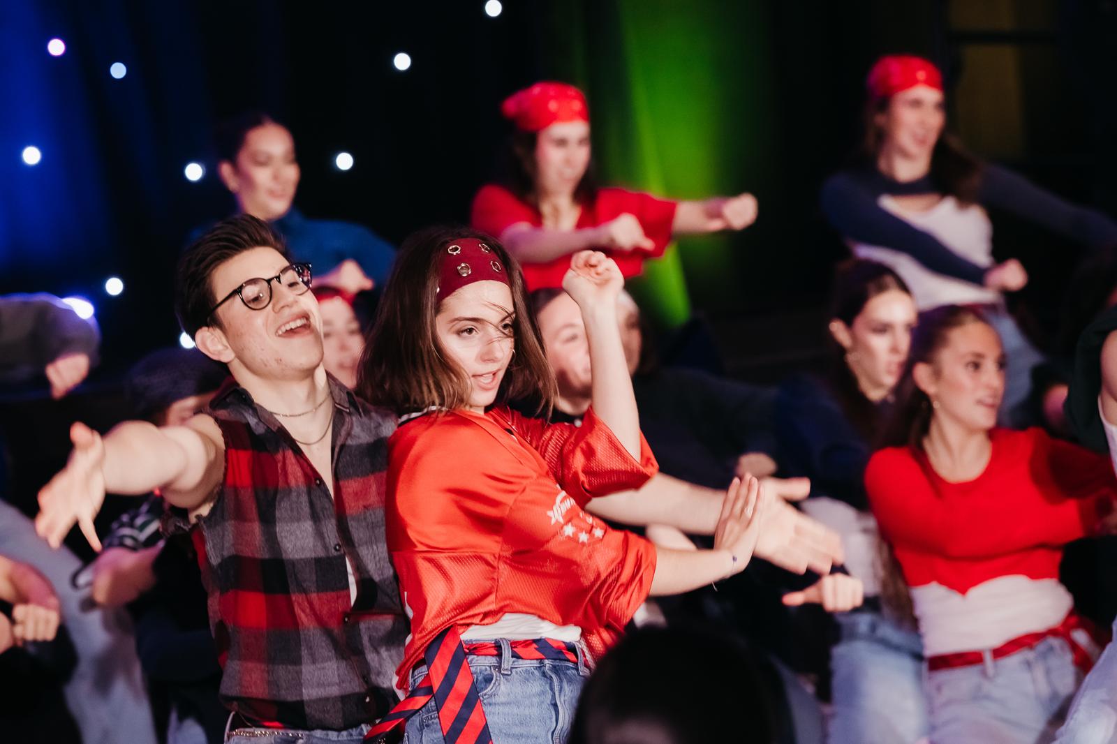 A group of dancers in red clothes performing